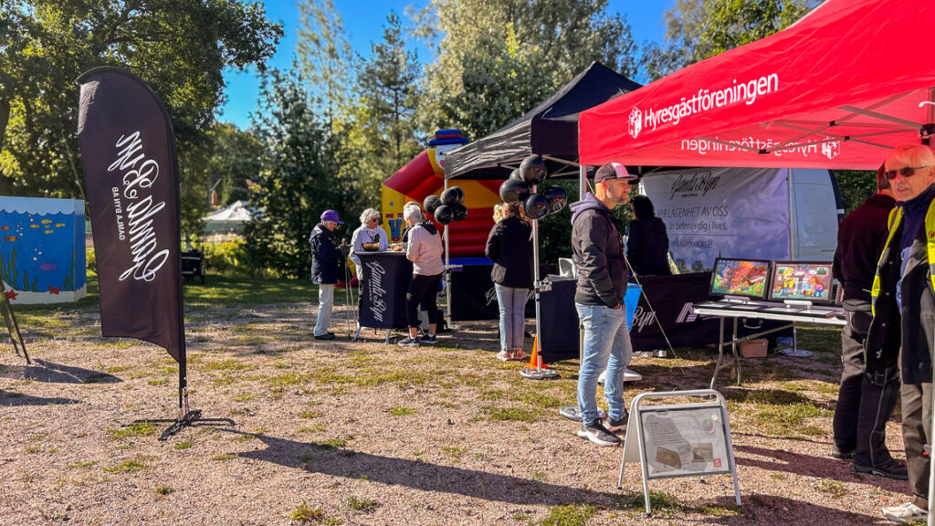 En grupp människor utanför två eventtält.